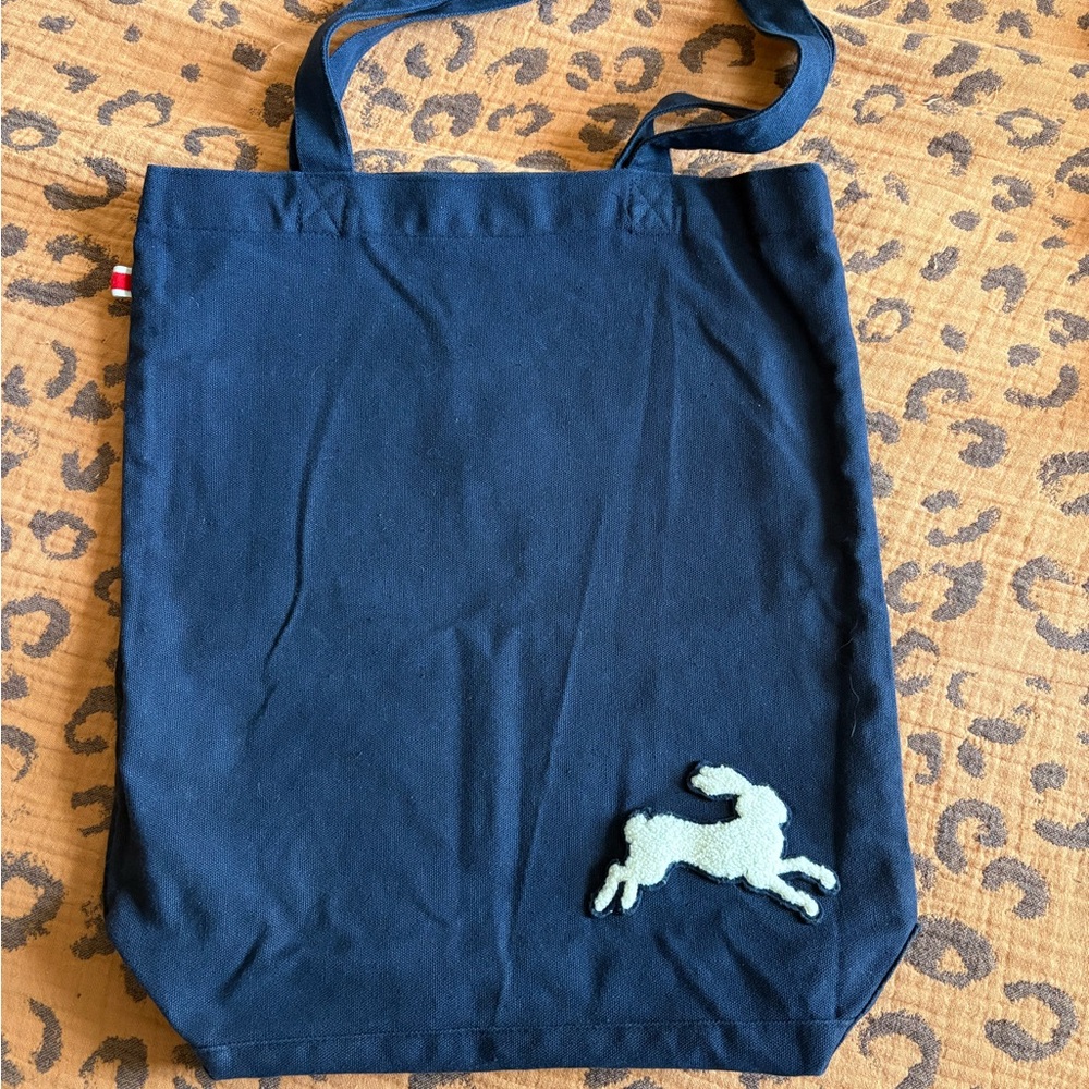 Tracksmith Navy Tote with white rabbit logo.